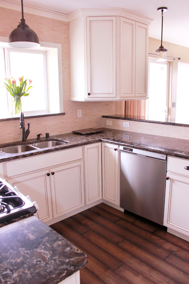 Enclosed kitchen - small transitional u-shaped dark wood floor enclosed kitchen idea with an undermount sink, beaded inset cabinets, white cabinets, quartzite countertops, beige backsplash and stainless steel appliances