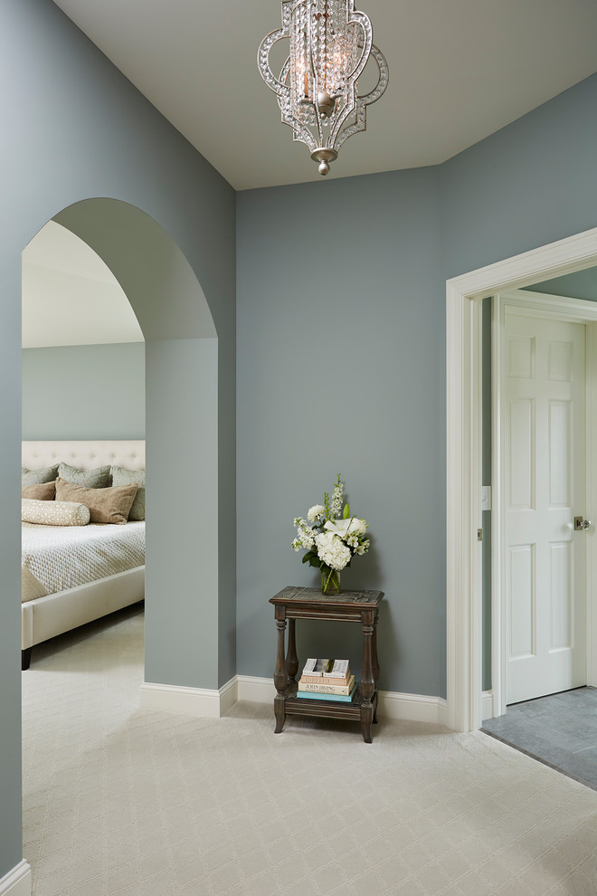 Inspiration for a large traditional master bedroom in Minneapolis with blue walls, carpet, no fireplace and white floor.