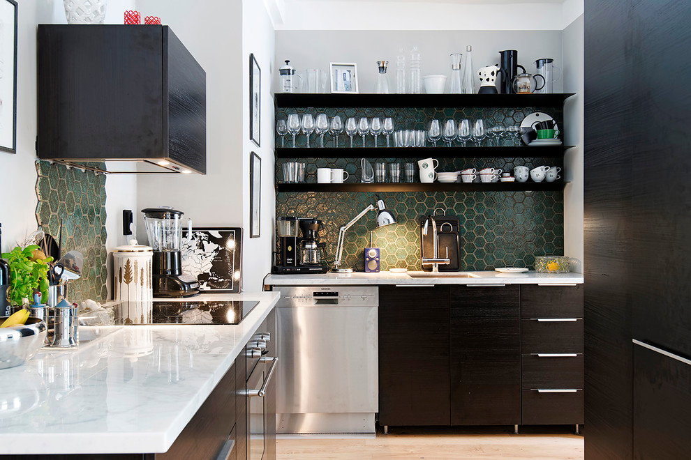 Design ideas for a large scandinavian l-shaped separate kitchen in Stockholm with an undermount sink, flat-panel cabinets, black cabinets, green splashback, stainless steel appliances, light hardwood floors, no island and marble benchtops.