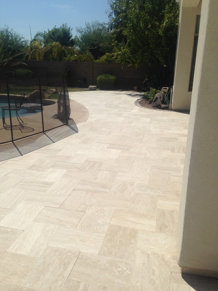 This is an example of an expansive traditional backyard patio in Phoenix.