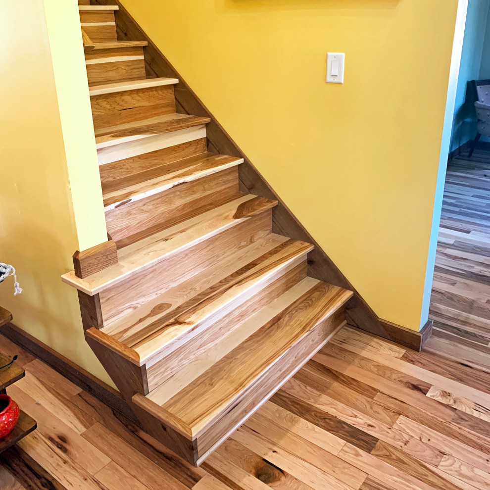 Medium sized country wood straight wood railing staircase in Other with wood risers.
