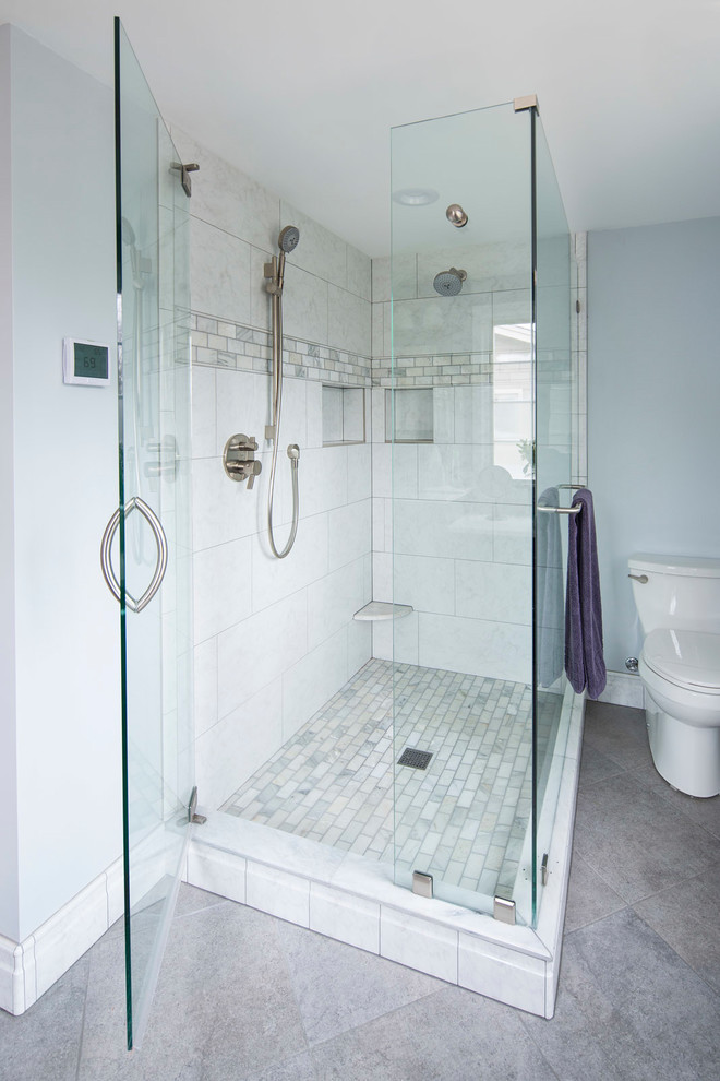 Transitional bathroom in Minneapolis with recessed-panel cabinets, dark wood cabinets, a corner shower, white tile, marble, purple walls, marble floors, engineered quartz benchtops, grey floor and a hinged shower door.