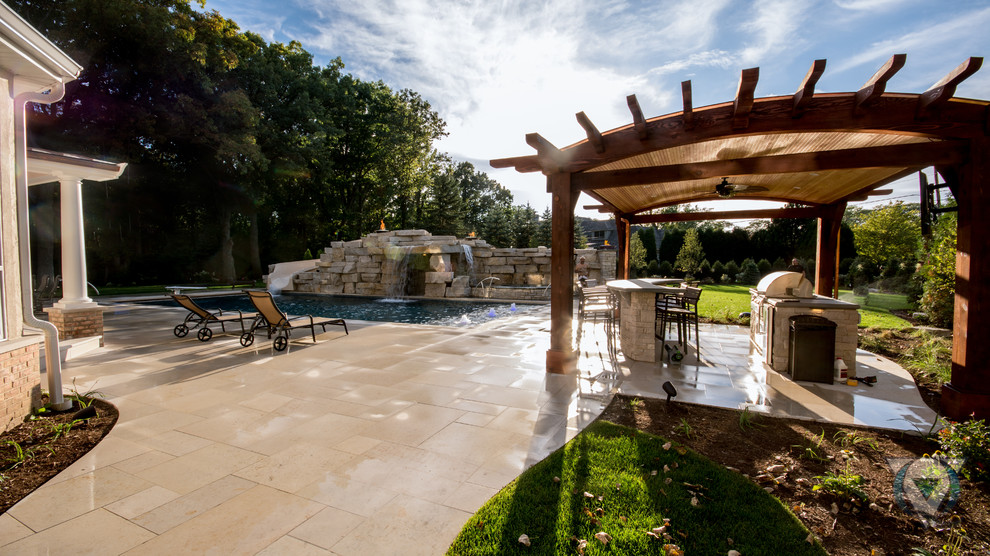 Large mountain style backyard stone and rectangular natural pool fountain photo in Chicago