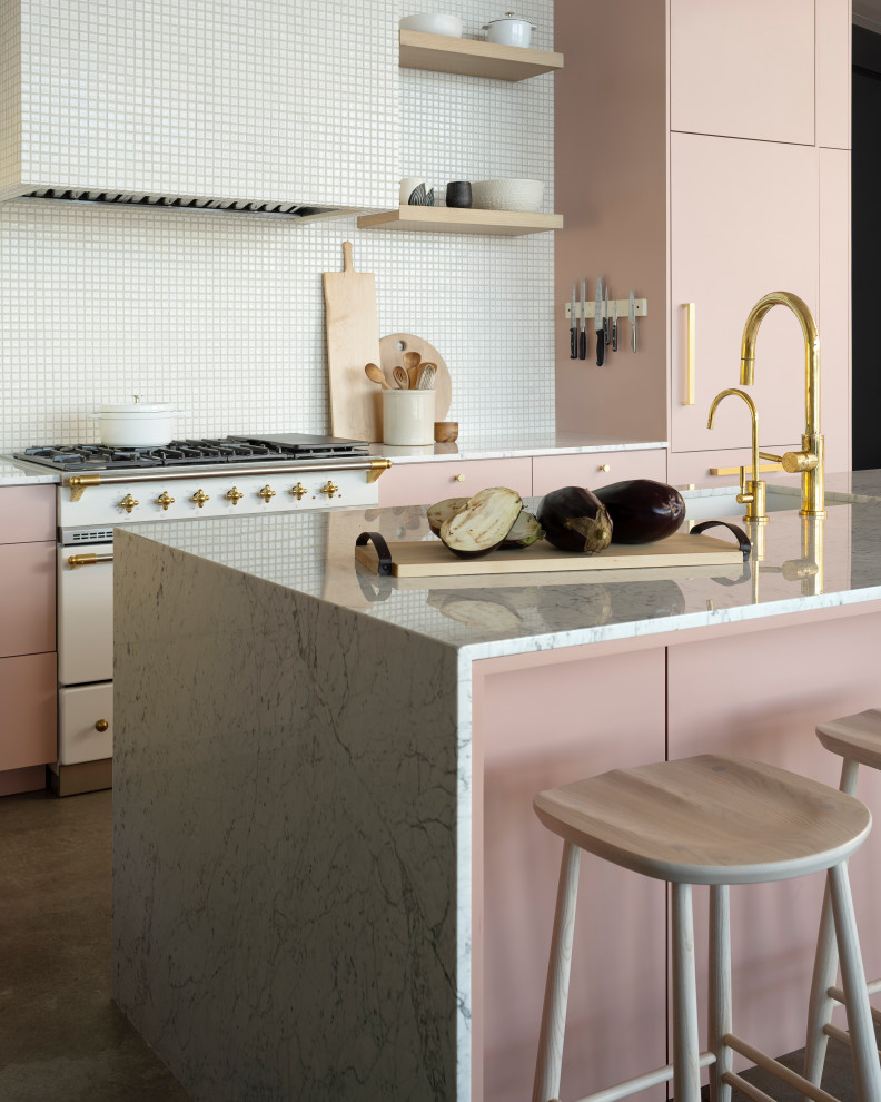 Inspiration for a mid-sized modern l-shaped eat-in kitchen in Other with an undermount sink, pink cabinets, marble benchtops, yellow splashback, mosaic tile splashback, white appliances, concrete floors, with island, flat-panel cabinets, grey floor and multi-coloured benchtop.