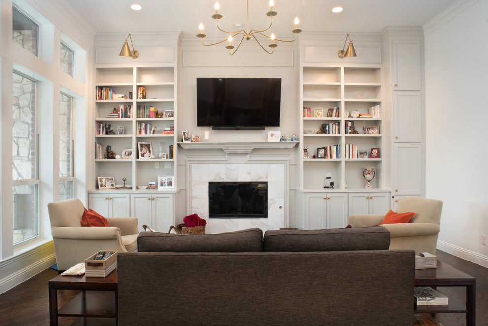 Inspiration for a large timeless open concept dark wood floor and brown floor living room remodel in Dallas with white walls, a standard fireplace, a tile fireplace and a wall-mounted tv