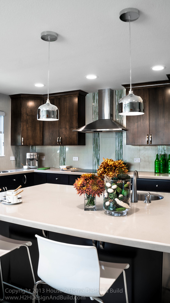 Mid-sized modern l-shaped eat-in kitchen in San Francisco with an undermount sink, flat-panel cabinets, medium wood cabinets, quartz benchtops, green splashback, glass tile splashback, stainless steel appliances, porcelain floors and with island.