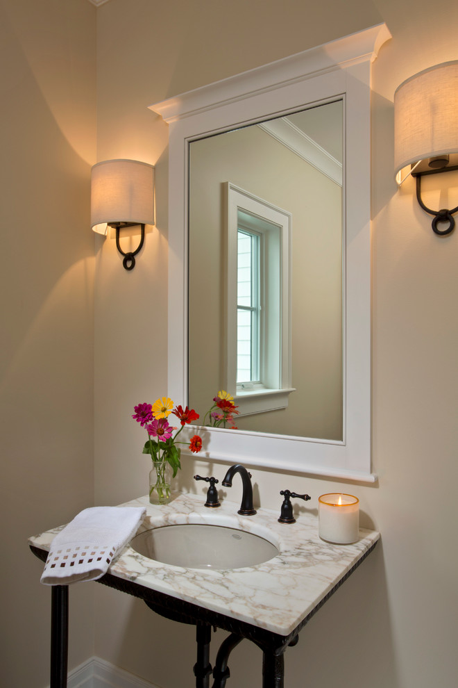 Country powder room in Boston with a console sink, beige walls and marble benchtops.