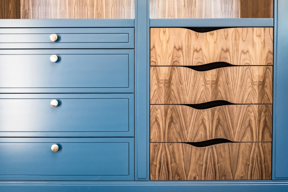 Design ideas for a mid-sized contemporary gender-neutral walk-in wardrobe in London with shaker cabinets and dark wood cabinets.