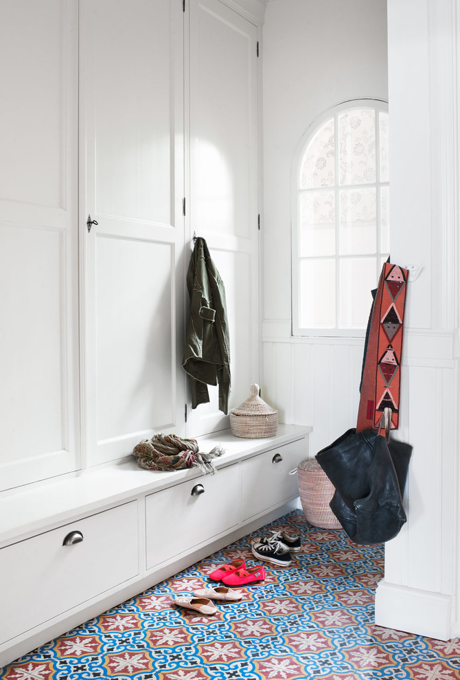 Photo of a mid-sized scandinavian mudroom in Gothenburg with white walls and porcelain floors.