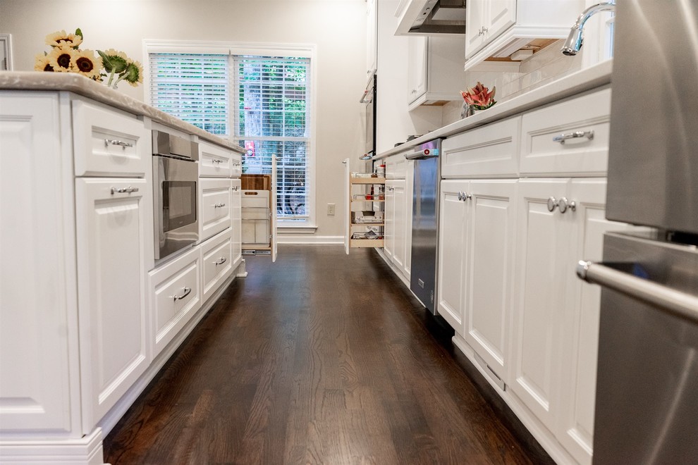 Modern kitchen in Atlanta with dark hardwood floors and brown floor.