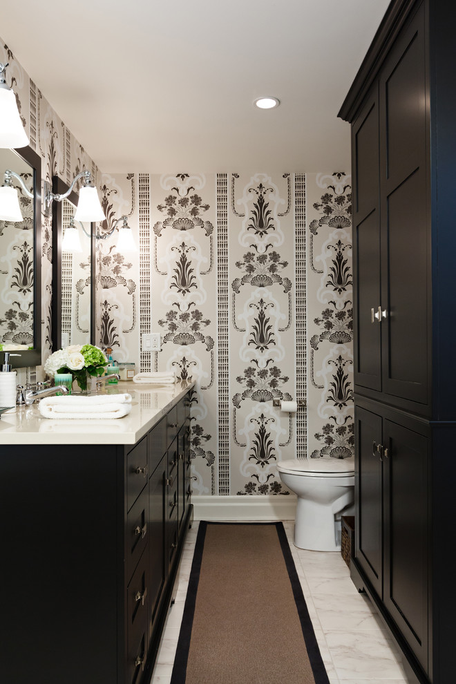 Design ideas for a small traditional powder room in Toronto with shaker cabinets, black cabinets, multi-coloured walls, a two-piece toilet, marble floors, an undermount sink, engineered quartz benchtops, grey floor and beige benchtops.