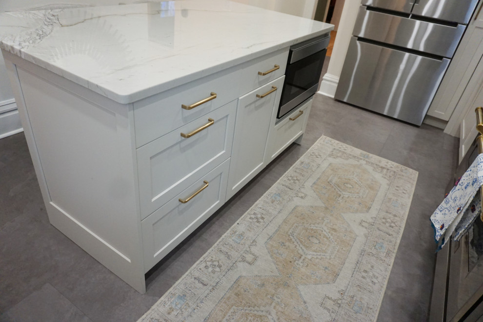 Kitchen - transitional vinyl floor and gray floor kitchen idea with an undermount sink, shaker cabinets, gray cabinets, quartzite countertops, stone slab backsplash, stainless steel appliances and an island