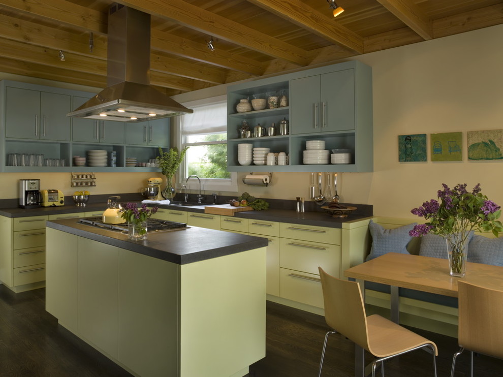 This is an example of a mid-sized eclectic l-shaped open plan kitchen in San Francisco with open cabinets, green cabinets, black splashback, dark hardwood floors, with island and an undermount sink.