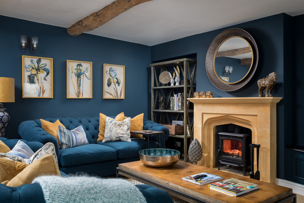 Large country formal enclosed living room in Gloucestershire with blue walls, a wood stove and no tv.