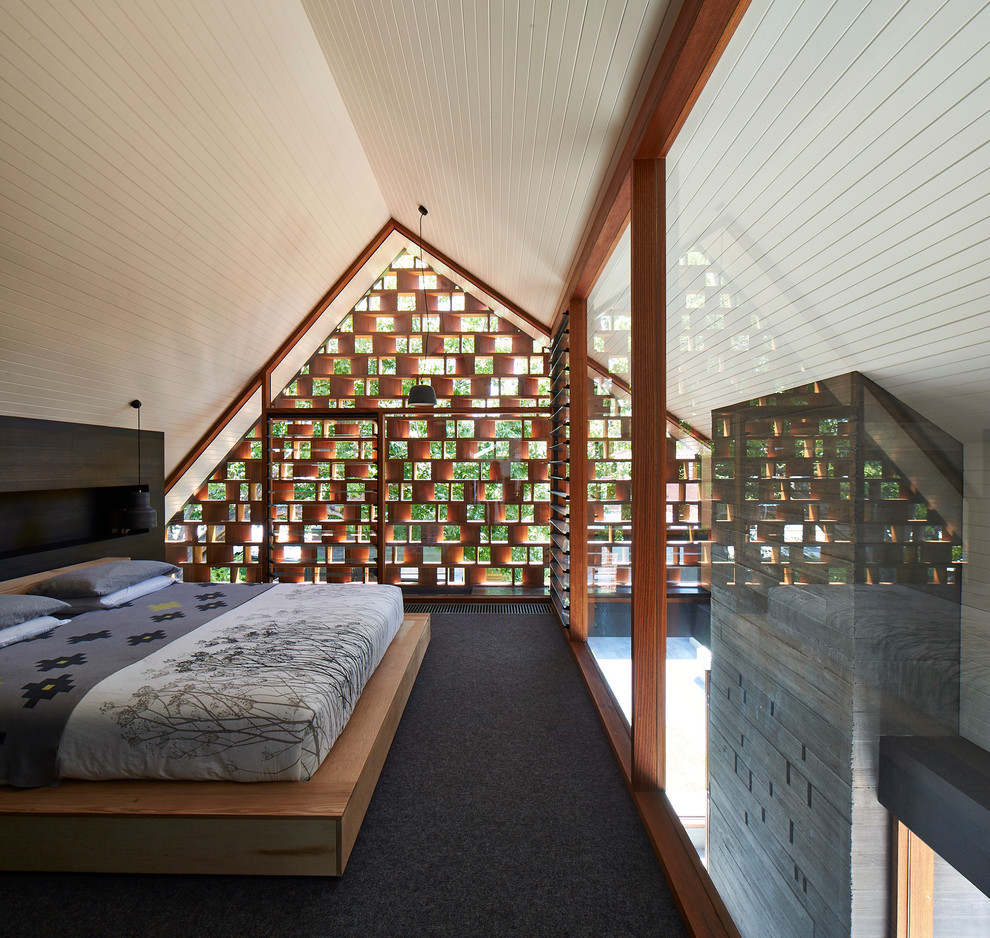 Contemporary master bedroom in Melbourne with carpet.