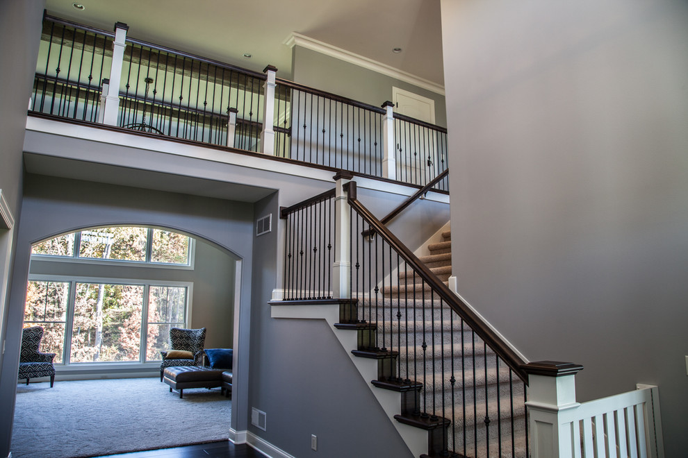 Staircase - large transitional carpeted l-shaped wood railing staircase idea with wooden risers