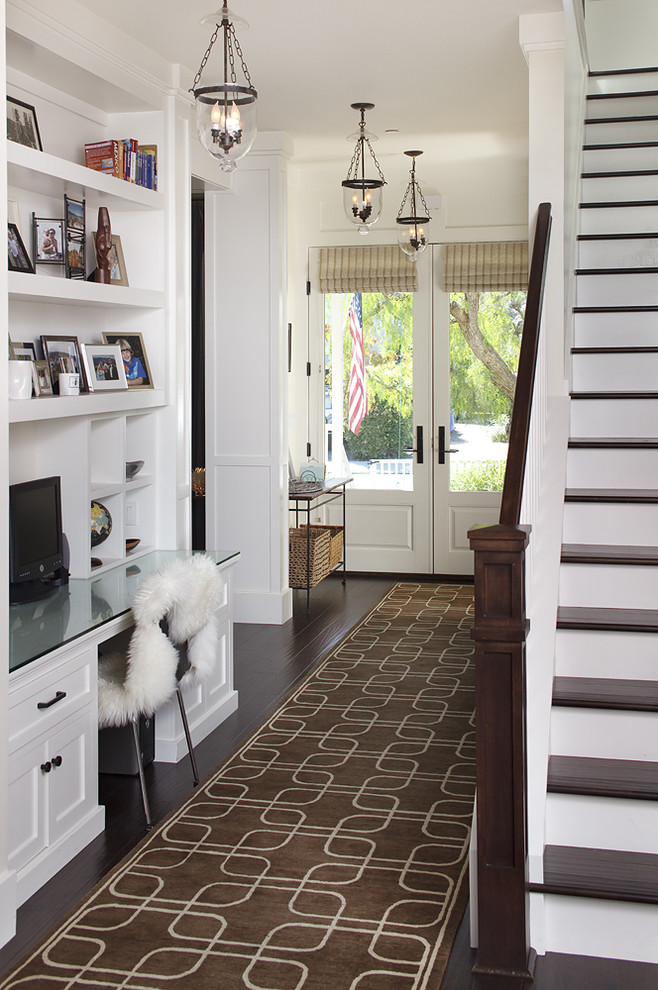 Inspiration for a traditional hallway in San Francisco with white walls and dark hardwood floors.