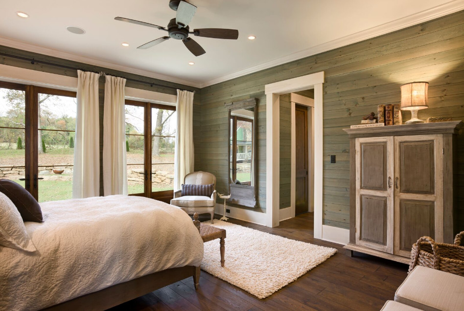 This is an example of a large arts and crafts master bedroom in Other with green walls, dark hardwood floors and no fireplace.