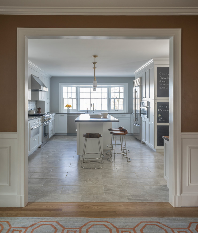 Inspiration for a contemporary u-shaped separate kitchen in Boston with a farmhouse sink, shaker cabinets, white cabinets, stainless steel appliances, with island, grey floor, wood benchtops, multi-coloured splashback and ceramic splashback.