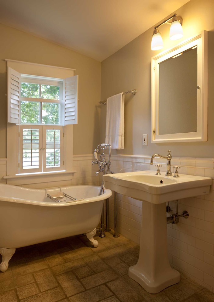 This is an example of a mid-sized country master bathroom in Boston with a claw-foot tub, white tile, ceramic tile, a pedestal sink and beige walls.