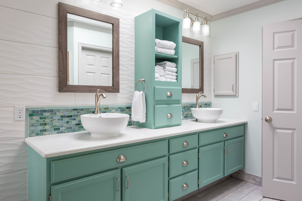Large transitional master bathroom in Seattle with turquoise cabinets, a freestanding tub, white tile, glass tile, porcelain floors, a vessel sink, engineered quartz benchtops, grey floor, a hinged shower door, a corner shower, white walls and recessed-panel cabinets.
