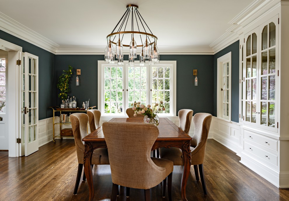 Design ideas for a traditional separate dining room in Portland with dark hardwood floors and blue walls.