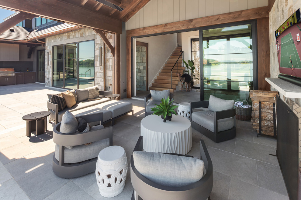 Large trendy backyard stone patio photo with a bbq area and a roof extension