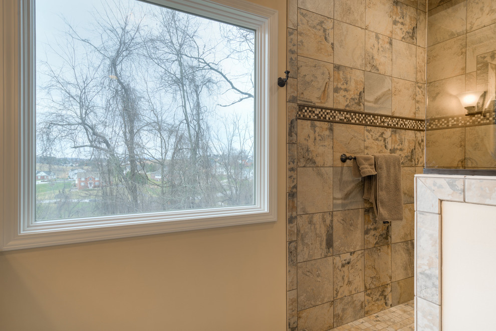 Mid-sized transitional master multicolored tile ceramic tile home design photo with raised-panel cabinets, beige cabinets, a two-piece toilet, beige walls, an undermount sink and quartz countertops