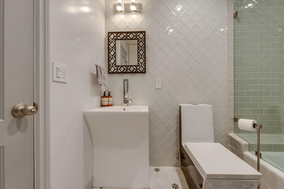 This is an example of a large asian master bathroom in San Francisco with recessed-panel cabinets, white cabinets, an alcove tub, a shower/bathtub combo, a one-piece toilet, white tile, ceramic tile, white walls, ceramic floors, an integrated sink and limestone benchtops.