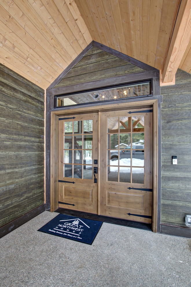 Photo of a large country front door in Seattle with a double front door and a medium wood front door.