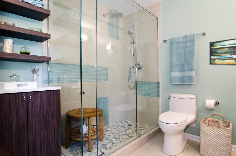 This is an example of a contemporary bathroom in Chicago with flat-panel cabinets, dark wood cabinets, an alcove shower, a one-piece toilet, blue tile and matchstick tile.