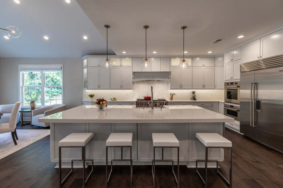 Design ideas for a large modern kitchen/diner in DC Metro with white cabinets, quartz worktops, white splashback, stainless steel appliances, an island and white worktops.