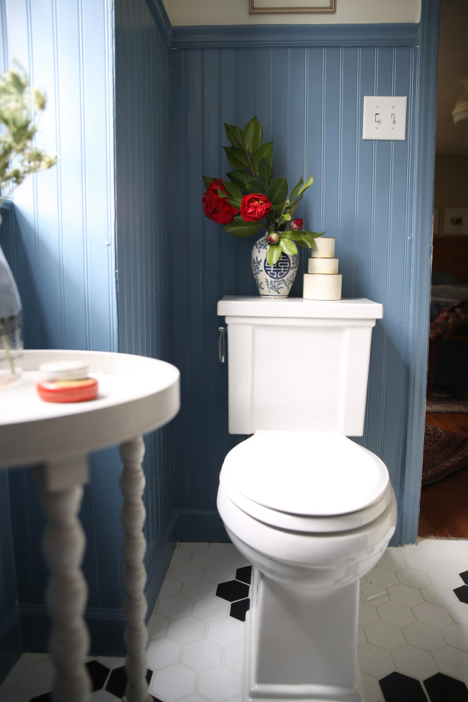 Photo of a mid-sized beach style bathroom in Raleigh with blue walls, ceramic floors, multi-coloured floor and a niche.