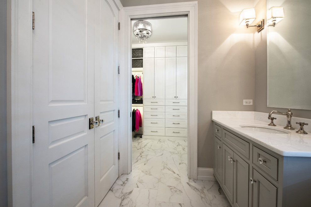 Inspiration for a mid-sized modern gender-neutral walk-in wardrobe in Chicago with shaker cabinets, white cabinets, marble floors and multi-coloured floor.