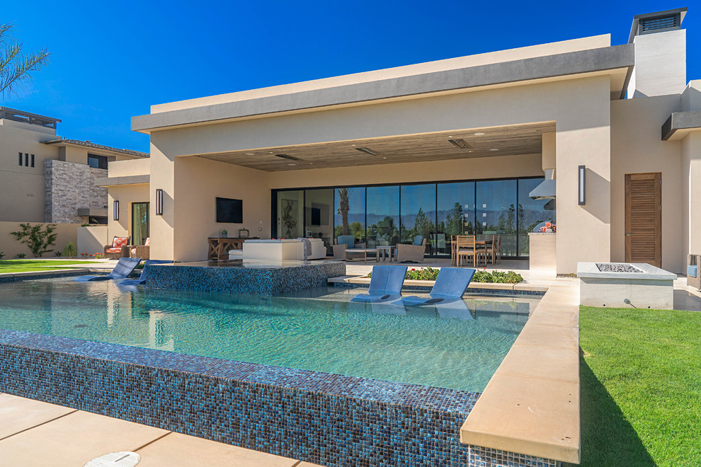 Photo of a contemporary backyard rectangular aboveground pool in Orange County with a hot tub.