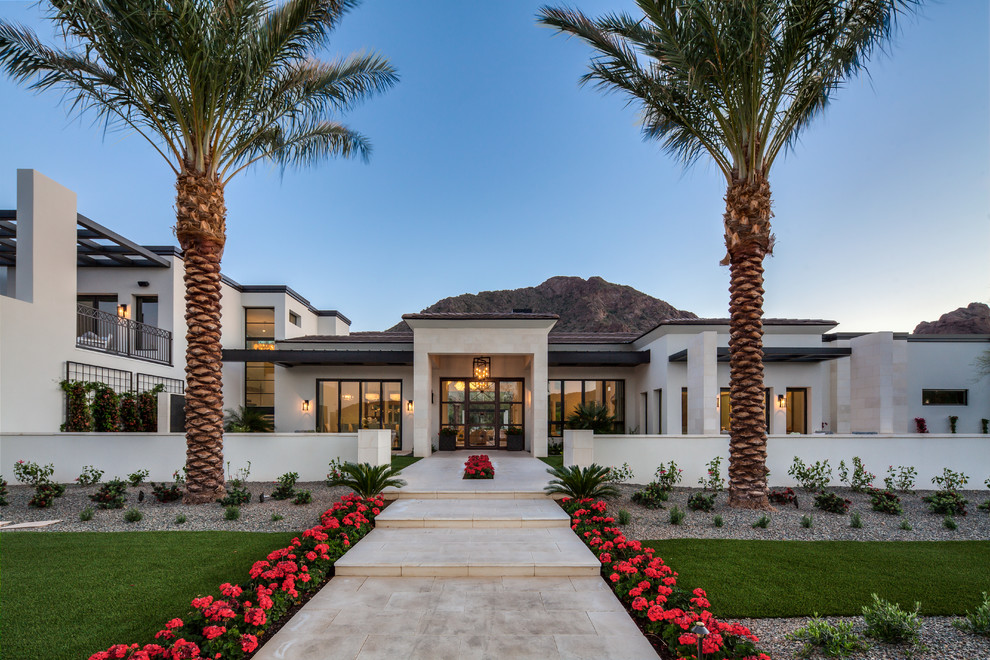 Photo of an expansive contemporary split-level white house exterior in Phoenix with a flat roof.