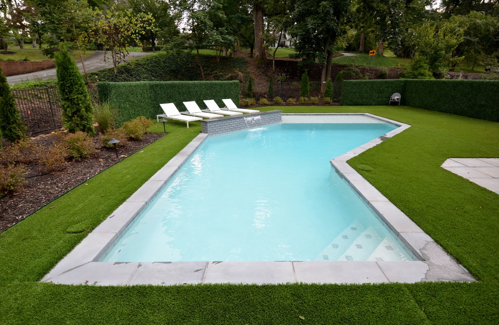 Mid-sized minimalist backyard custom-shaped and concrete paver lap pool fountain photo in Other