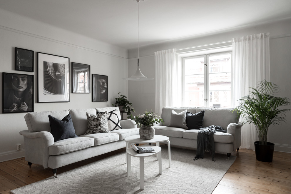 Design ideas for a scandinavian living room in Other with grey walls, light hardwood floors and beige floor.