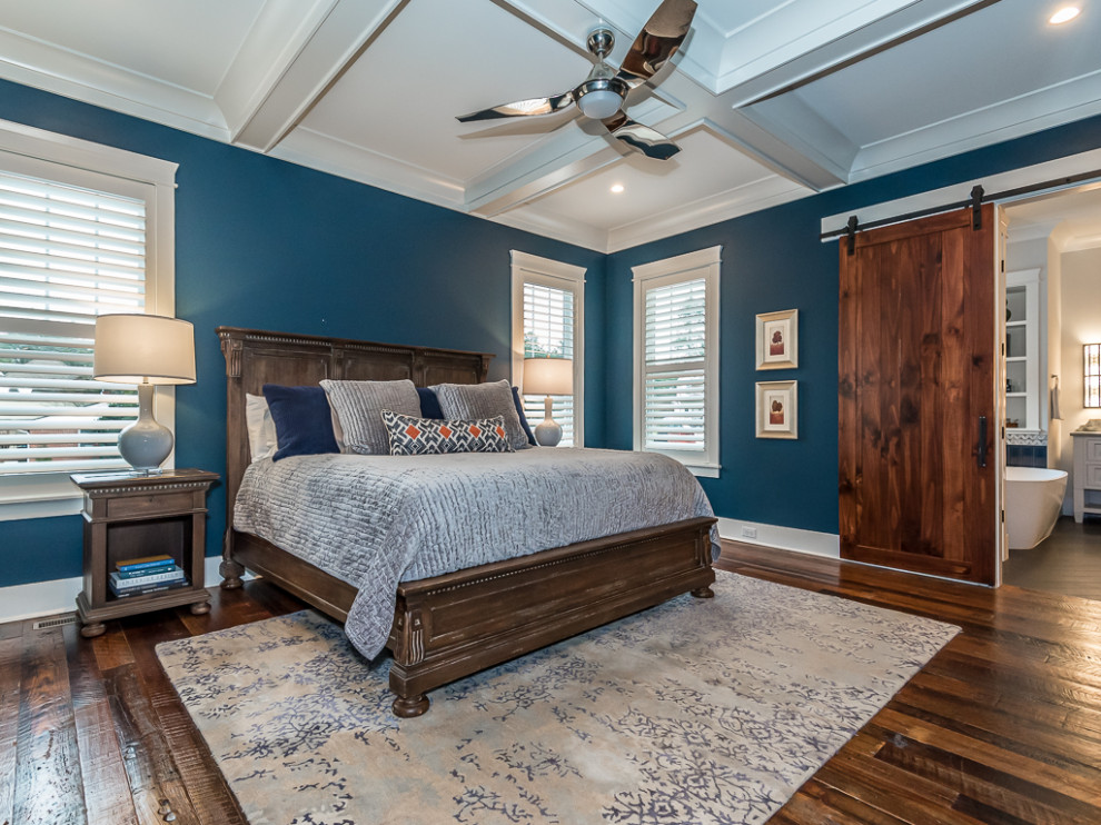Contemporary master bedroom with blue walls, medium hardwood floors and coffered.