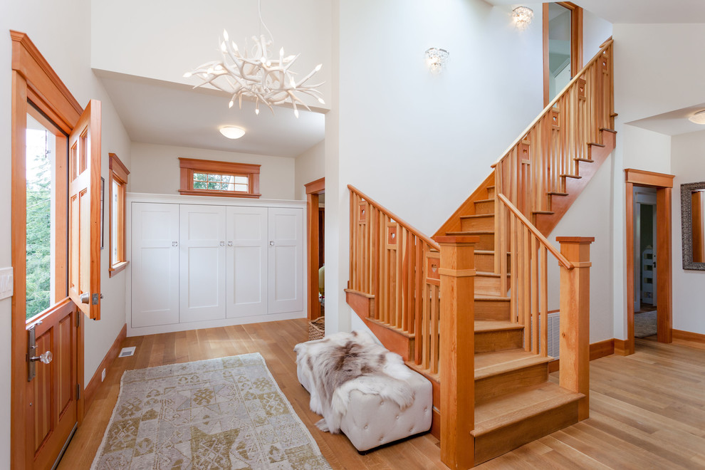 Photo of a mid-sized transitional foyer in San Francisco with medium hardwood floors, a dutch front door, white walls and a medium wood front door.