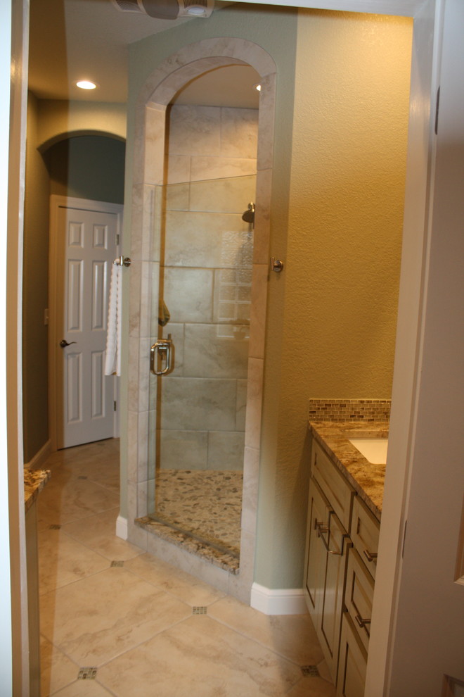 Inspiration for a large transitional master multicolored tile and porcelain tile porcelain tile corner shower remodel with raised-panel cabinets, green cabinets, an undermount tub, green walls, an undermount sink and granite countertops