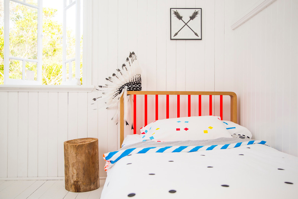 Mid-sized eclectic gender-neutral kids' bedroom in Sydney with white walls and light hardwood floors.