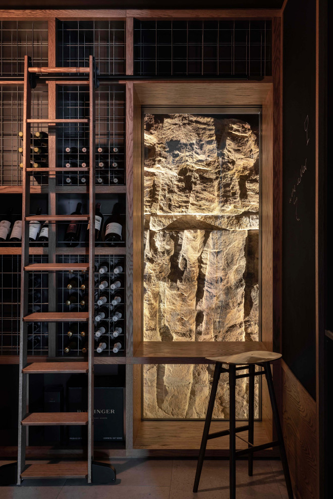 This is an example of a beach style wine cellar in Sydney.