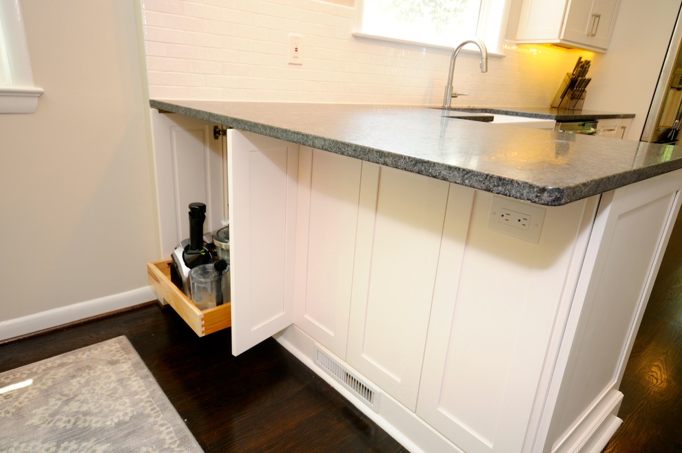 Inspiration for a mid-sized transitional galley dark wood floor eat-in kitchen remodel in DC Metro with a farmhouse sink, shaker cabinets, white cabinets, granite countertops, white backsplash, subway tile backsplash, stainless steel appliances and a peninsula