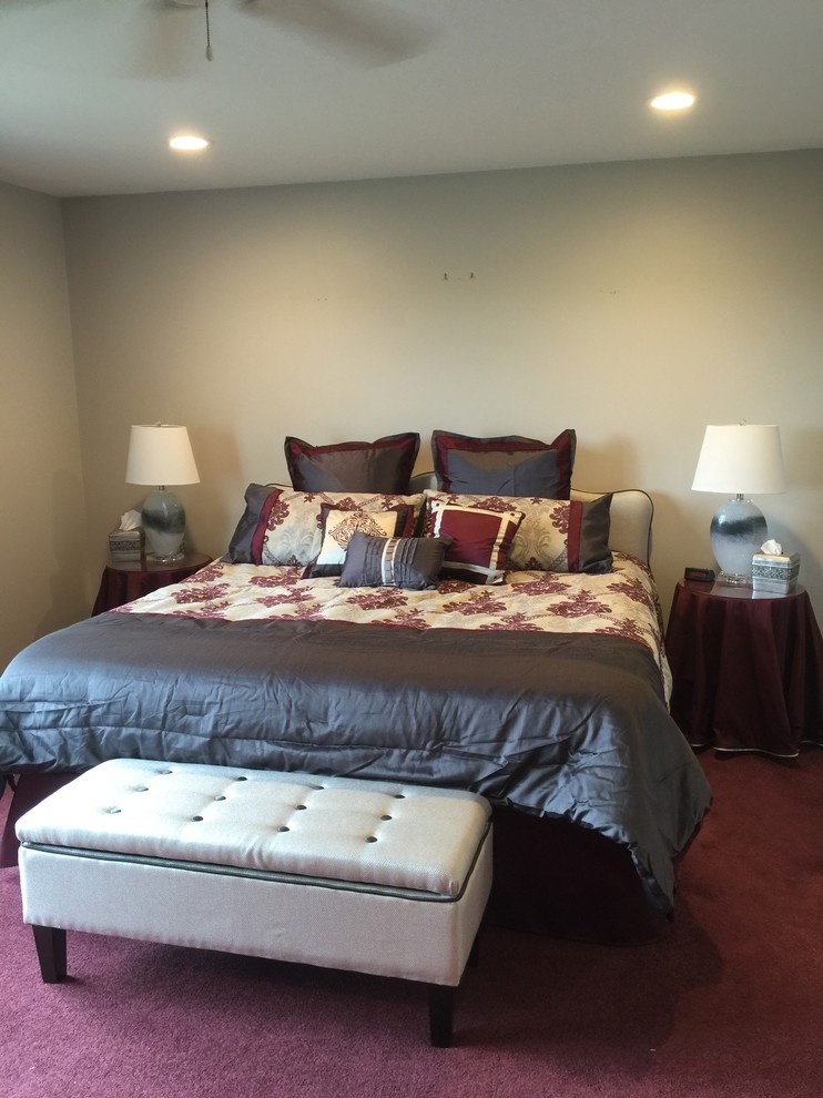 Large traditional master bedroom in Cincinnati with grey walls, carpet, no fireplace and red floor.