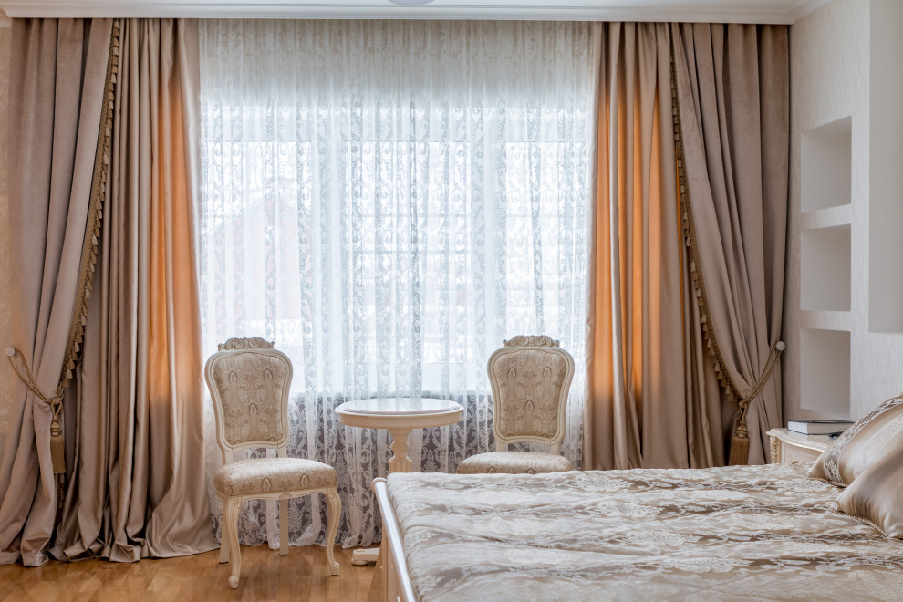 Imagen de dormitorio principal clásico grande con paredes rosas, suelo de madera en tonos medios, suelo beige y bandeja