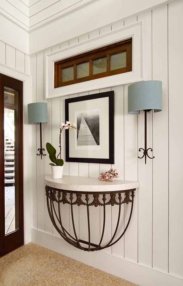 Beach style entry hall photo in Charleston with white walls and a dark wood front door