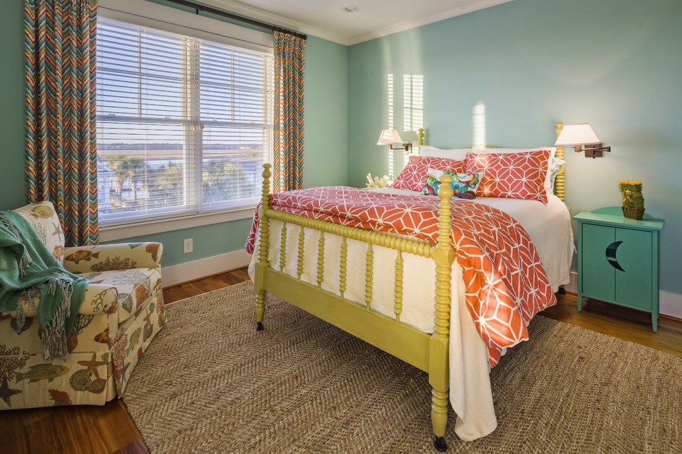 Example of a large beach style master light wood floor bedroom design in Charleston with blue walls and no fireplace