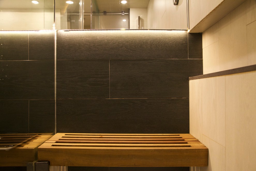 Design ideas for a small industrial bathroom in New York with gray tile, porcelain tile and with a sauna.
