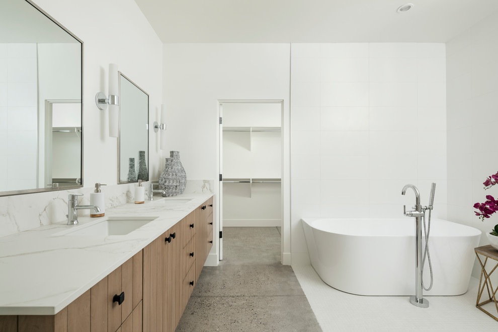Inspiration for a contemporary bathroom in Phoenix with flat-panel cabinets, brown cabinets, a two-piece toilet, white tile, porcelain tile, white walls, concrete floors, a drop-in sink, engineered quartz benchtops, grey floor, an open shower, a freestanding tub and an open shower.